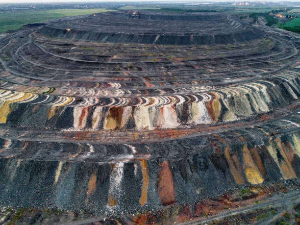 istock Huge mound of waste rocks. Industrial dump of a mining quarry. Overburden, multi-colored 1317544416