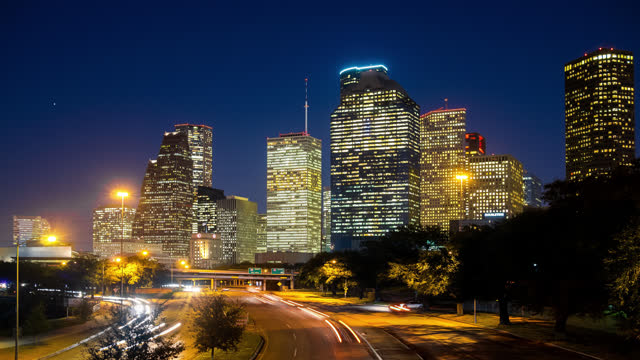 Timelapse view of the Houston City skyline at dusk with traffic moving at night