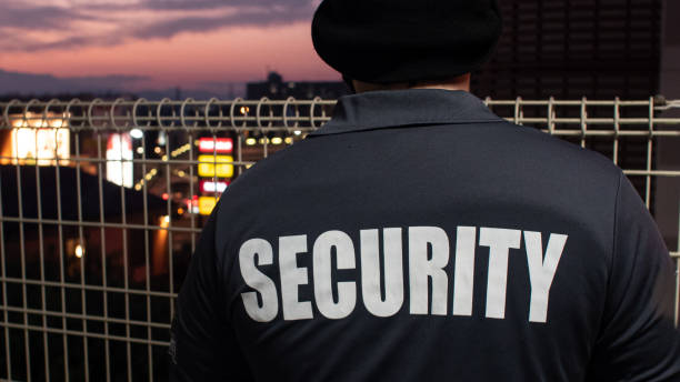 istock Security guard looking down street and sunset 1317545181