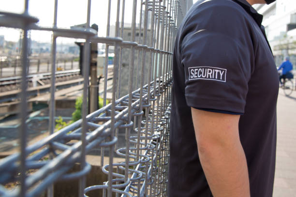 istock Security guard in uniform patrolling residential area nearby railway. 1317545205