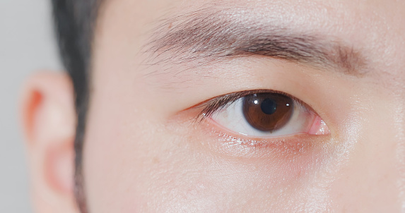 male eye close up from asian young man half face