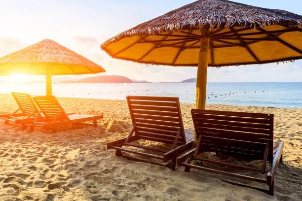 istock Wooden sun bed and umbrella on tropical beach. 1317547003