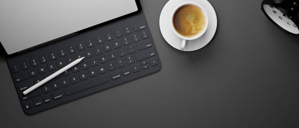 istock Digital tablet with keyboard and stylus pen on black table with coffee cup and copy space, 3D rendering 1317548439