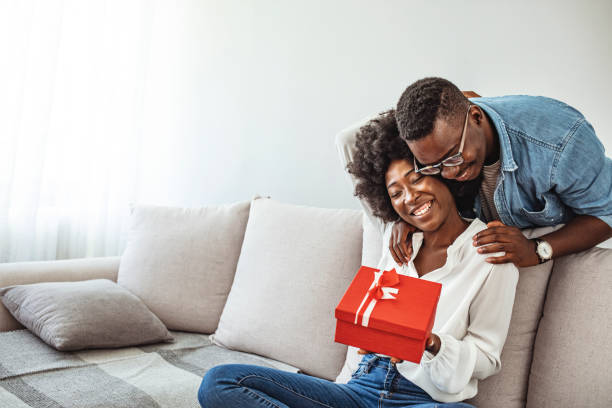 istock Young couple celebrating Christmas at home 1317554435