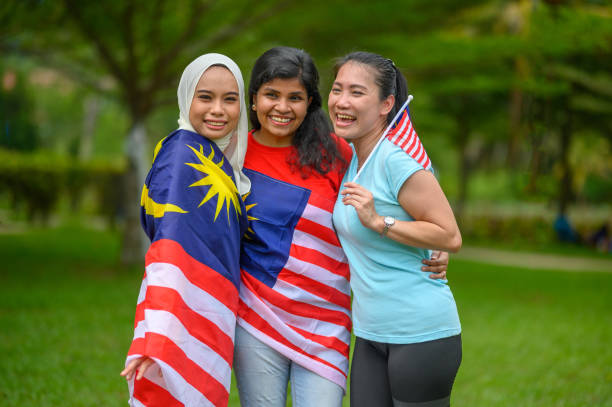 istock Malaysian multi-ethnic group people with Malaysian flag at public park 1317558954