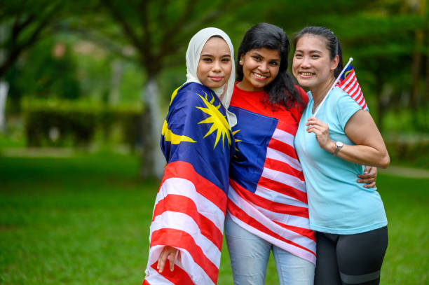 istock Malaysian multi-ethnic group people with Malaysian flag at public park 1317558983