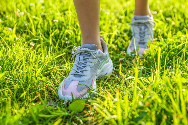 istock woman's legs wearing sport sneakers 1317559005