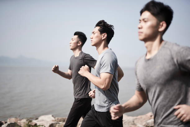 istock young asian male runner running by the sea 1317559206