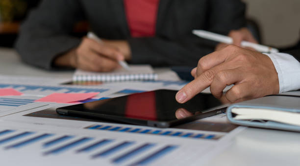 istock A business man working with a tablet computer and analyzing graphs of finance in the office 1317559259