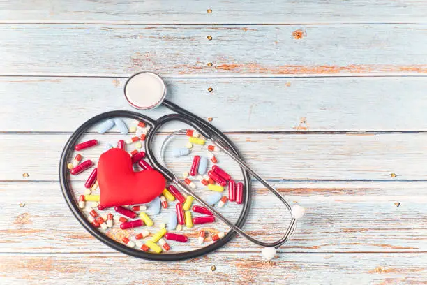 Photo of Stethoscope, pills and red heart. Heart check. Health concept. World heart day. World health day