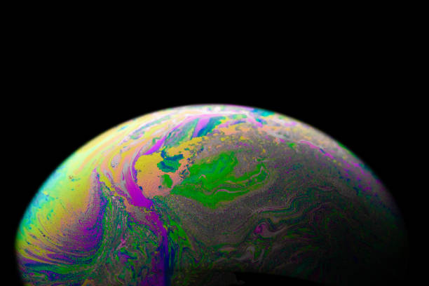 istock Colourful bubbles. Abstract galaxy background with globe planet earth in universe space with sunlight on dark background. Abstract colorful soap bubble. 1317560332