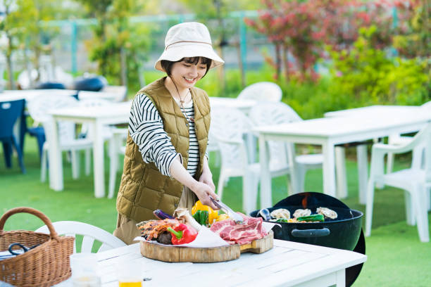 Woman baking ingredients on BBQ