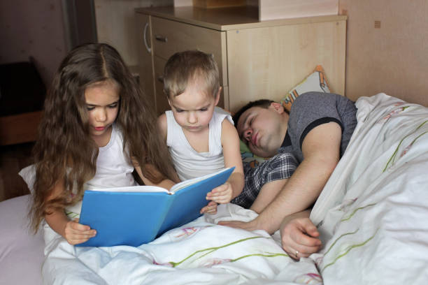 istock Father reading a book to his children 1317563550