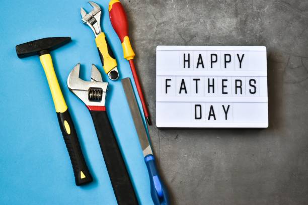 istock Light box with the inscription HAPPY FATHER'S DAY with construction tools on a gray concrete and blue background. Holiday concept.
Flat lay. 1317567293