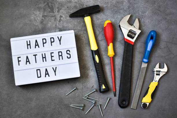istock Light box with the inscription HAPPY FATHER'S DAY with construction tools on a gray concrete background. Holiday concept.
Flat lay. 1317567357