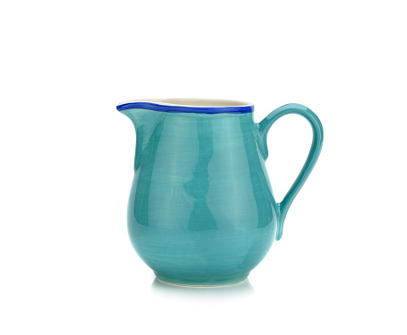 Green ceramic pitcher or creamer on white background