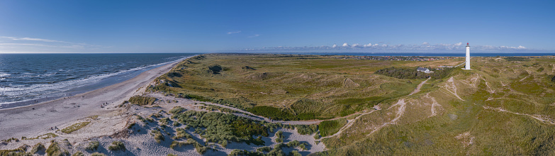 Panoramic aerial view of Lyngvig lighthouse on wide dune of Holmsland Klit with beach view on the west coast of Jutland, by Hvide Sande, Denmark