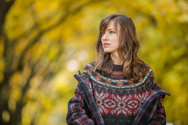 istock Woman walking in autumn park 1317569238