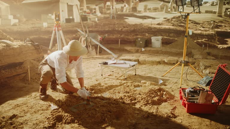 Archaeological Digging Site: Great Female Archeologist Work on Excavation Site, Cleaning Cultural Artifacts with Brush and Tools. Discovery of Ancient Civilization Temple, Architecture, Fossil Remains