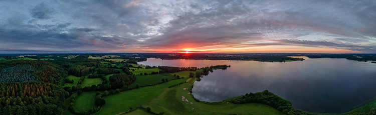 Sunset over the lake in nature reserve Westensee, Schleswig-Holstein, Germany