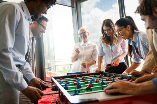 istock Coworkers playing table football on break from work 1317570292