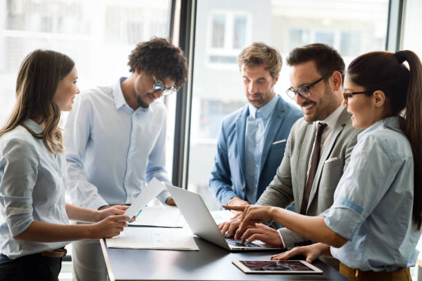 istock Group of business partners discussing documents and ideas at meeting 1317570303