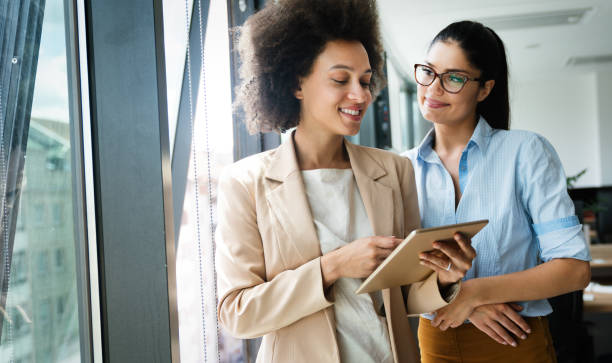 istock Happy business colleagues in modern office using tablet 1317570316