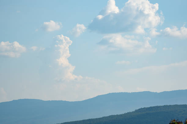 blue sky and white clouds over hills background on daytime