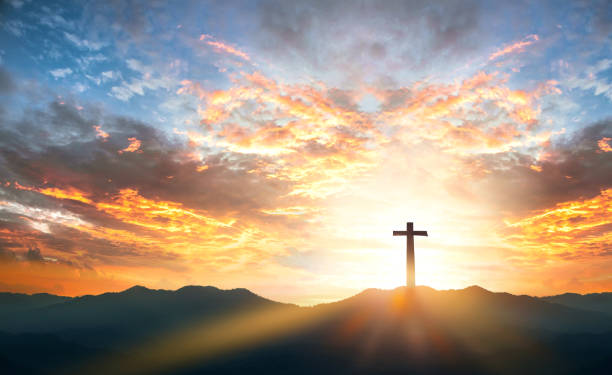 Religious day concept: Silhouette cross on  mountain sunset background stock photo