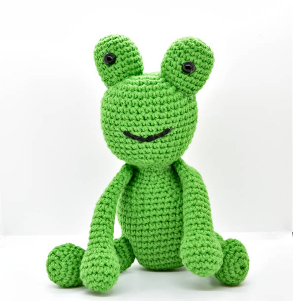 istock Cute green knitting frog 1317572428