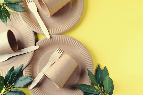 istock Disposable biodegradable tableware on craft paper - forks, glasses and plates. Zero Waste. Top view. 1317580413