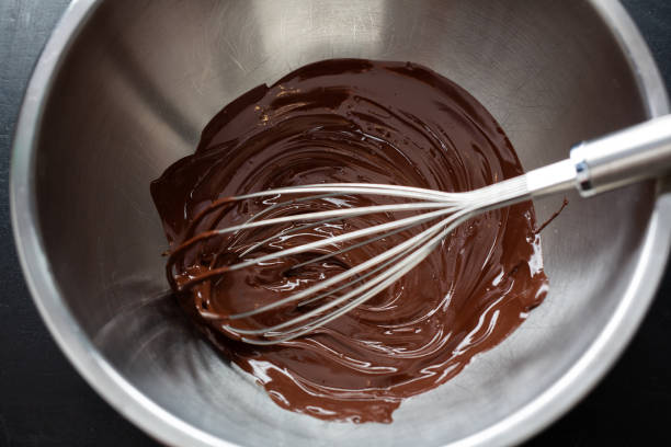 istock Melting chocolate in pot on dark 1317580838