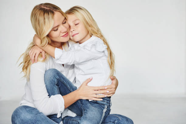 istock Mother with her daughter have fun together in the studio with white background 1317581010