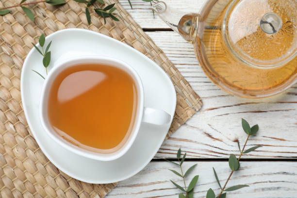 istock Aromatic eucalyptus tea on white wooden table, flat lay 1317581049