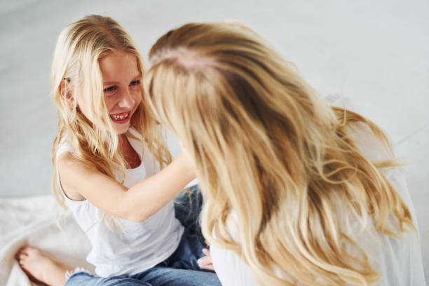 istock Mother with her daughter together in the studio with white background 1317581614