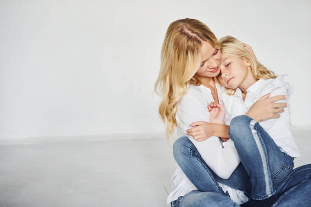 istock Mother with her daughter have fun together in the studio with white background 1317581636