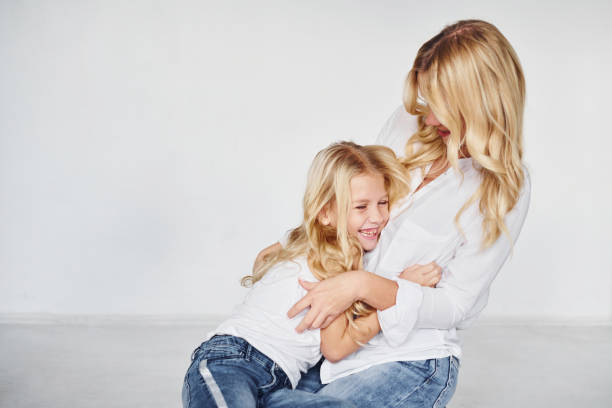 istock Mother with her daughter together in the studio with white background 1317581725