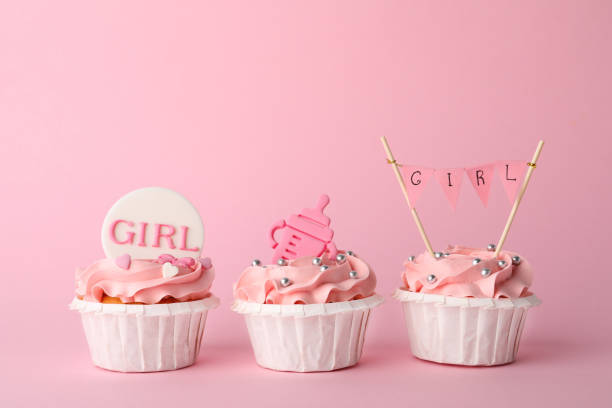 istock Baby shower cupcakes with toppers on pink background 1317581828