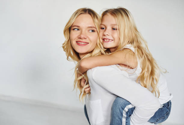 istock Mother with her daughter have fun together in the studio with white background 1317581976
