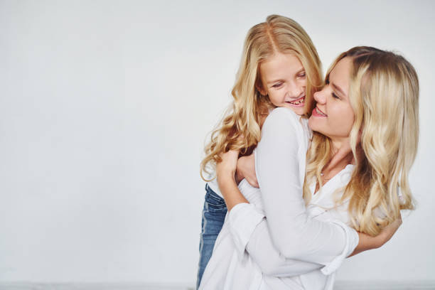 istock Mother with her daughter have fun together in the studio with white background 1317582024