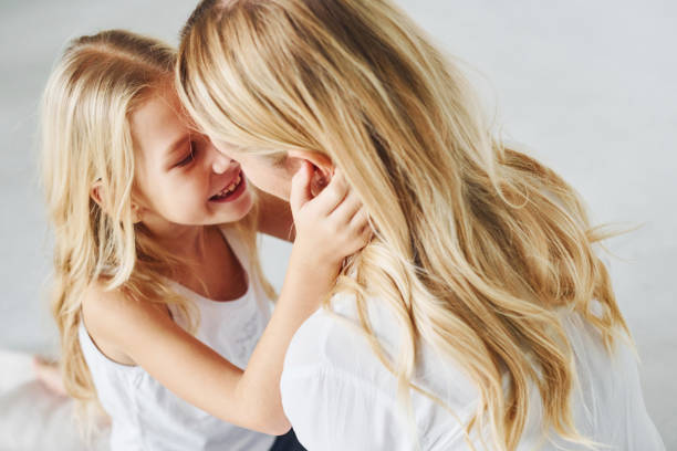 istock Mother with her daughter together in the studio with white background 1317582144
