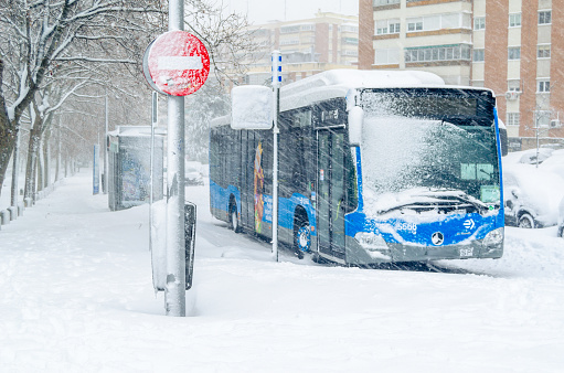 Madrid, Spain - January 9, 2021: Bus stranded due to snow during Storm Filomena, the heaviest snowfall in 50 years in Madrid, Spain