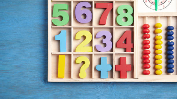 istock Colorful numbers on blue wooden table. Education. Learning 1317583531