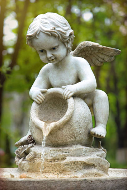 istock Cupid marble garden sculpture and decorative fountain 1317584759
