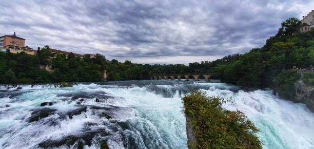 istock Spectacular waterfall in stormy weather with interesting cloud formation 1317584936