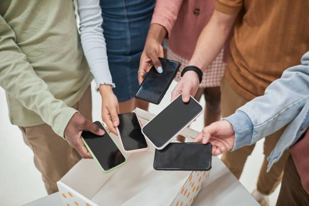 Students putting phones in box closeup