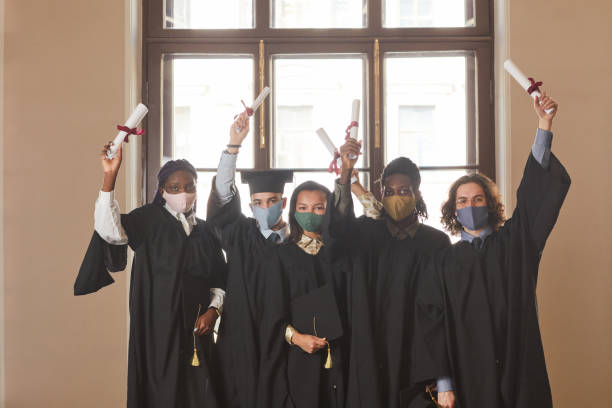 istock Young people wearing masks at graduation ceremony 1317585034