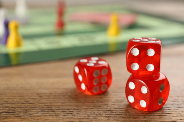 istock Closeup view of dices on wooden table, space for text. Board game 1317587870