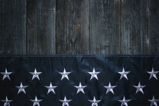 istock USA Flag on dark wooden background 1317589745