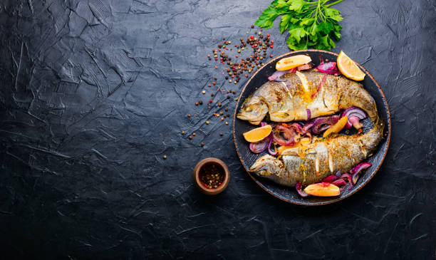 istock Baked trout with lemon on plate 1317590823
